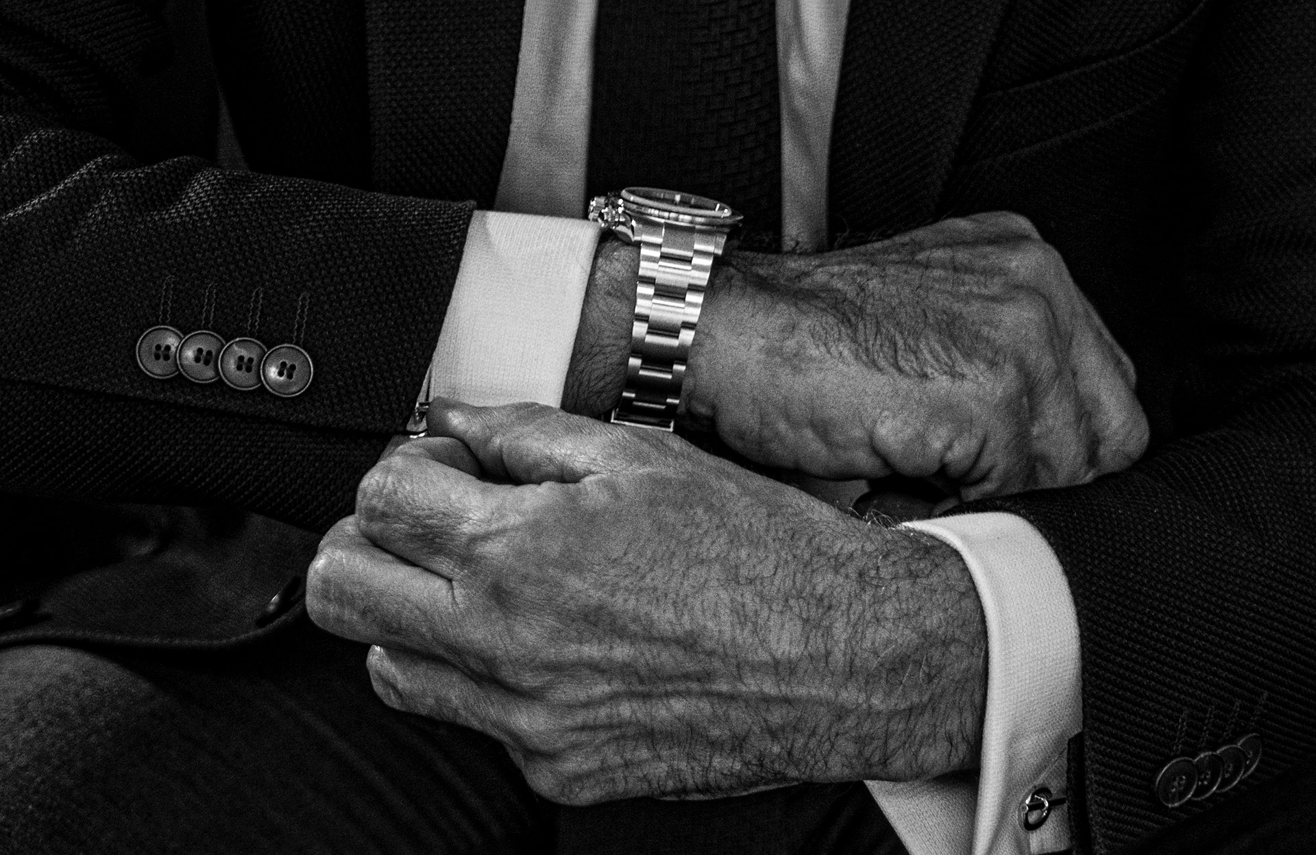 black and white picture of a man wearing his custom Artisans de Genève watch