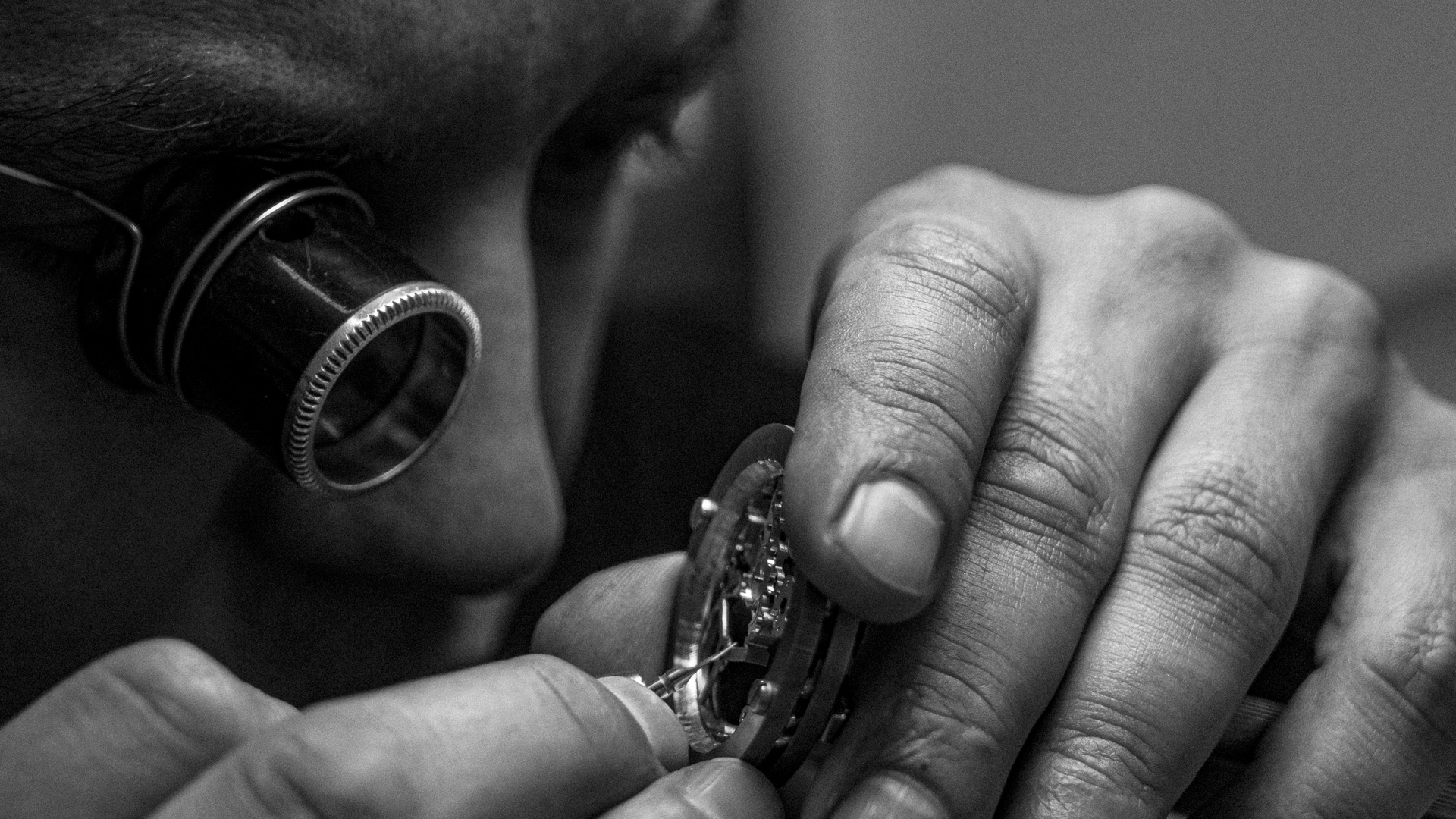 watchmaker doing beveling on a piece